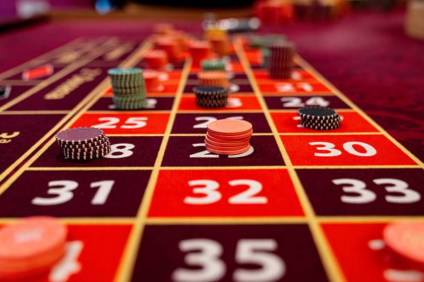 Microgaming slot game interface on mobile phone showing reels and spin button